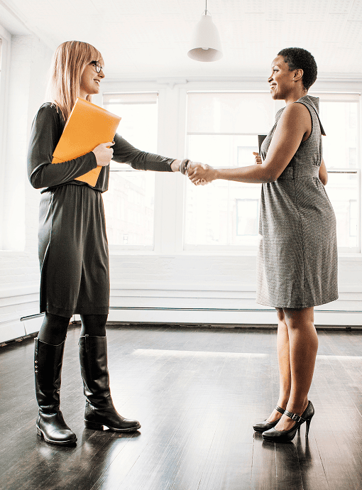 woman shaking hands with her Wilston mortgage broker after buying a home