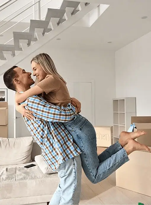 A couple celebrate in their new home after a Geebung mortgage broker helped them get finance.